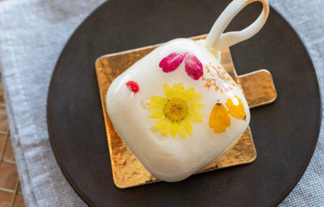 New to our holiday line-up, the Apricot Blossom Ornament will not only blow you away with its beauty, it's also an absolute joy to eat! Apricot gelée and whipped mascarpone ganache enrobed in white chocolate and decorated with delicately pressed edible flowers. Beautiful enough to hang on your tree, but we recommend enjoying it after dinner with a cup of espresso or tea!